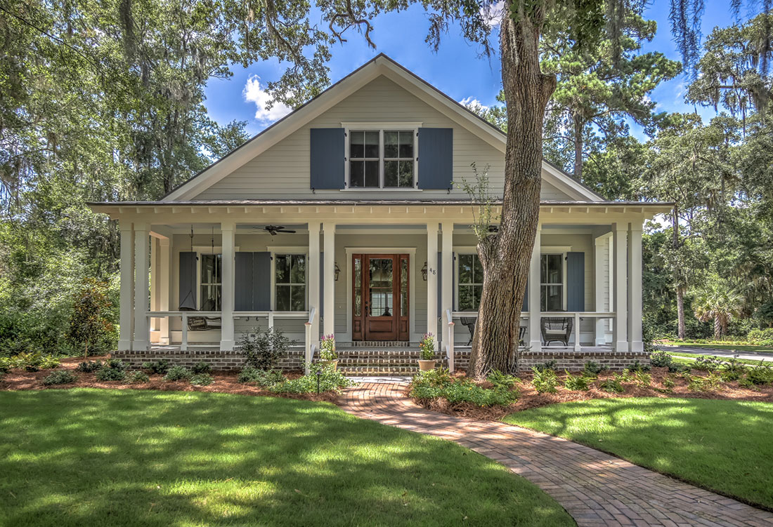 Front exterior of cottage-style home at 48 Gilded Street with wraparound porch and brick walkway Front exterior of cottage-style home at 48 Gilded Street with wraparound porch and brick walkway