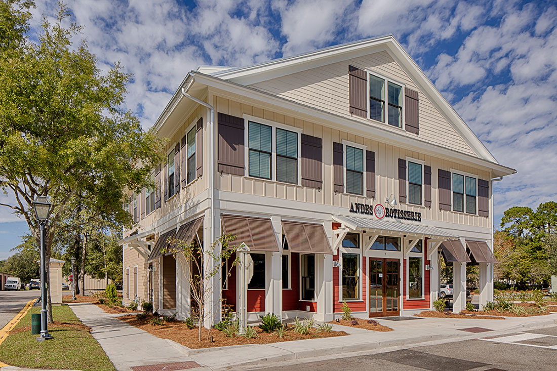 Exterior of the Andes Rotisserie restaurant building with red-trimmed storefront and striped awnings Exterior of the Andes Rotisserie restaurant building with red-trimmed storefront and striped awnings