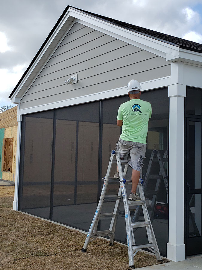 S3 Building Solutions worker installing screens on a screened porch structure