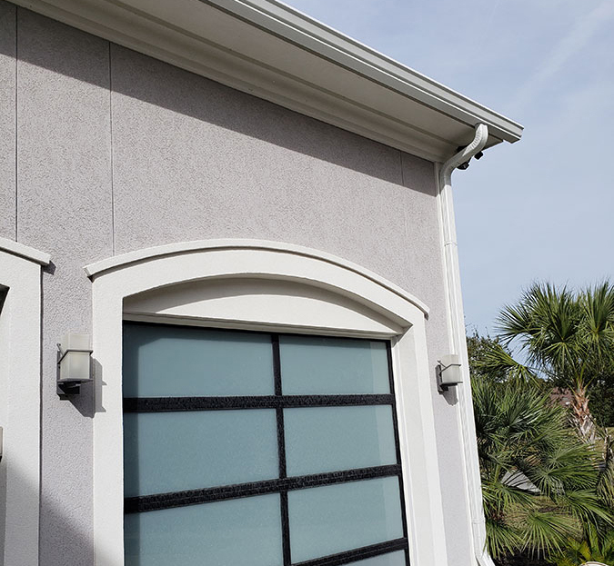 New seamless gutters installed along a residential roofline New seamless gutters installed along a residential roofline